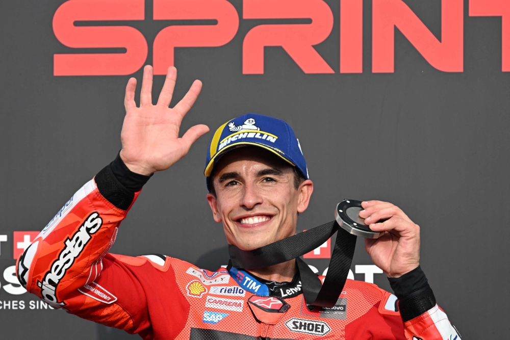 Ducati Lenovo Team's Spanish MotoGP rider Marc Marquez celebrates on the podium after finishing in second place during the MotoGP sprint race. (Photo by Toshifumi Kitamura / AFP)