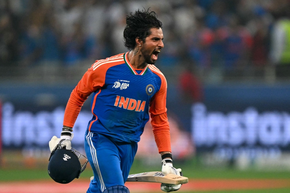 India's Tilak Varma celebrates their victory at the end of the Asia Cup 2025 Twenty20 international cricket final match between India and Pakistan at the Dubai International Stadium in Dubai on September 28, 2025. (Photo by Sajjad Hussain / AFP)