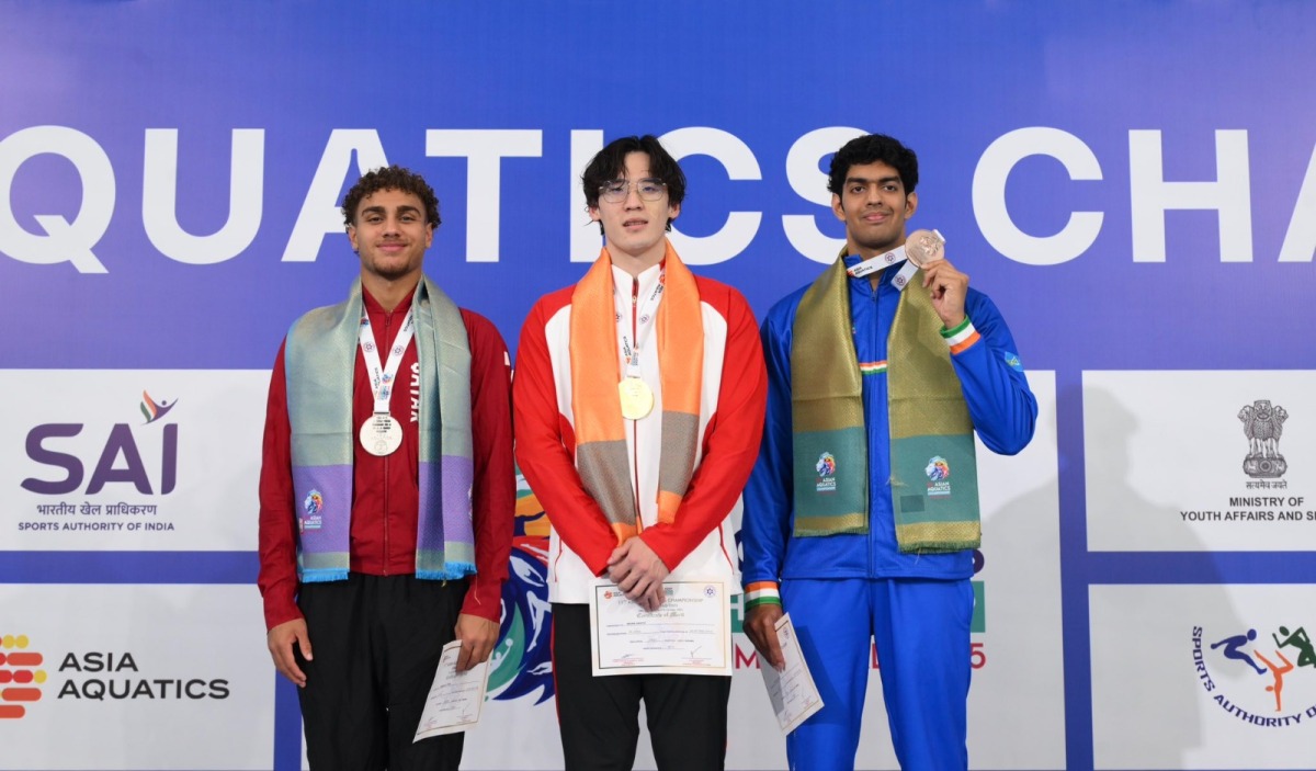 Qatar's Ali Tamer (left) celebrates on the podium with gold winner Wang of China and India’s Srihari Natraj who won the bronze, in the 100m freestyle event. 