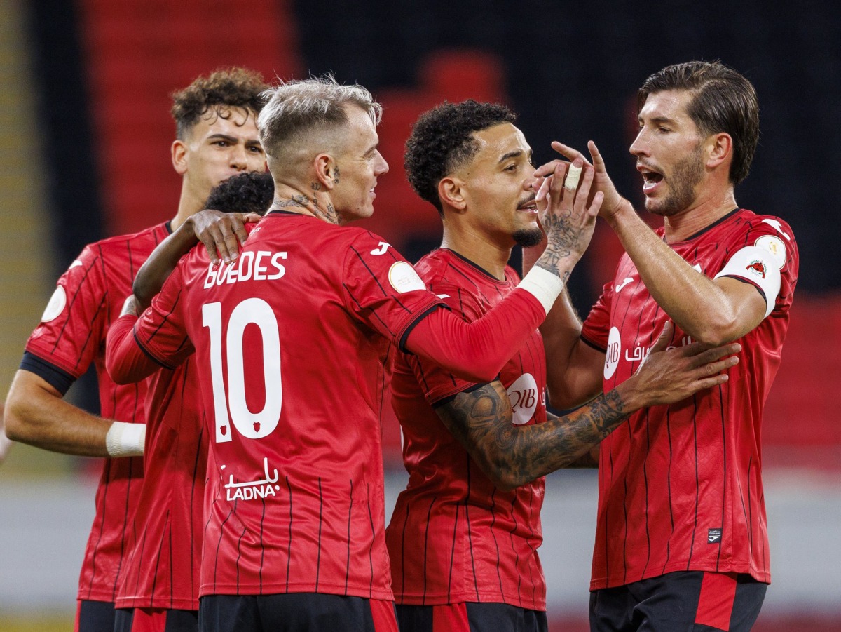 Al Rayyan's Roger Guedes (centre) celebrates with teammates.