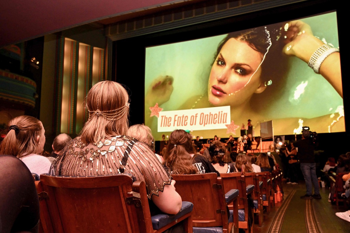 Taylor Swift fans listen to a song during a listening event for Swift's new album 'The Life of a Showgirl' at the Astor Theatre in Melbourne on October 3, 2025. Photo by William WEST / AFP