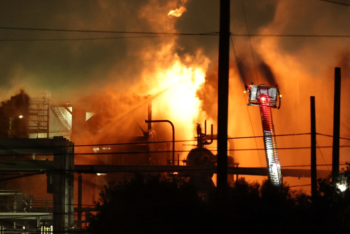 A firefighting crew works to contain a fire at the Fire Chevron Products Company El Segundo Refinery in the early morning hours on October 3, 2025, in El Segundo, California, following an explosion at the oil refinery that occurred late on October 2. Photo by Patrick T. Fallon / AFP