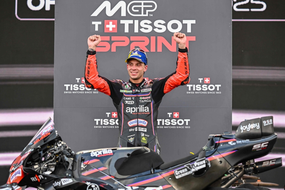 Aprilia Racing team's Italian MotoGP rider Marco Bezzecchi celebrates on the podium after winning the Sprint Race at the MotoGP Indonesian Grand Prix on October 4, 2025. C (Photo by Sonny Tumbelaka / AFP)