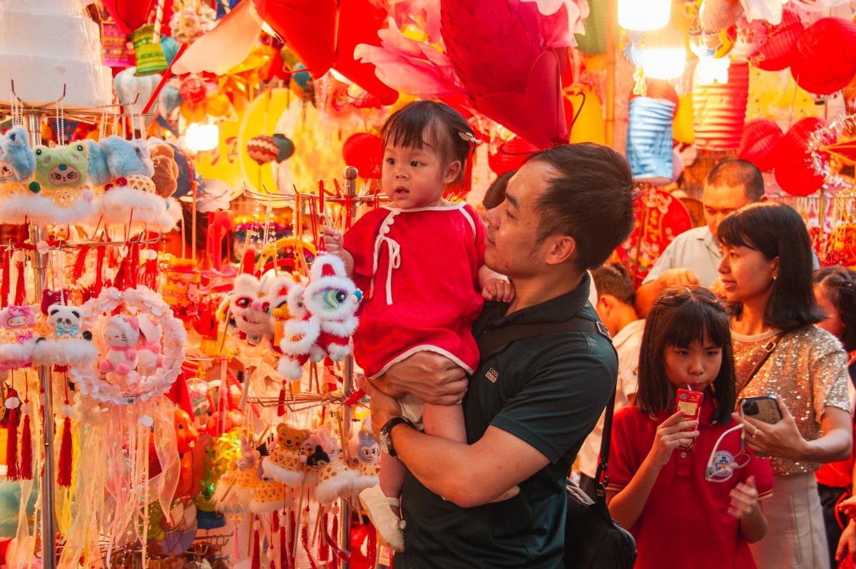 People shop for the Mid-Autumn Festival at Hang Ma Street in Hanoi, Vietnam, Oct. 3, 2025. Hanoi's Hang Ma Street is brightly decorated with lanterns and festive items for the upcoming Mid-Autumn Festival. (Photo by Dang Hong Dung/Xinhua)