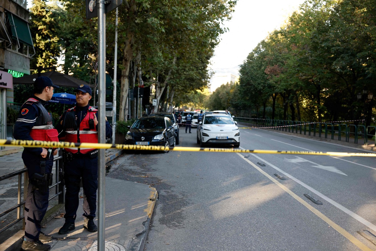 Police officers secure the perimeter outside the Appeal Court where a judge was shot dead, in Tirana on October 6, 2025. (Photo by Adnan Beci / AFP)
