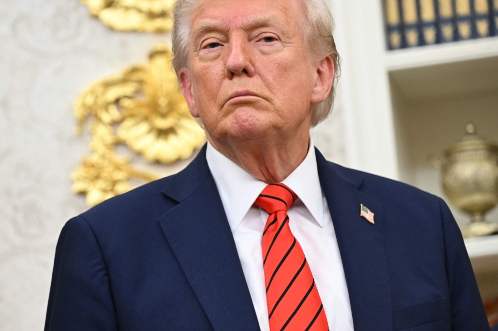 US President Donald Trump looks on during the announcement of a deal to lower drug prices with drug maker AstraZeneca at the Oval Office of the White House in Washington, DC, on October 10, 2025. (Photo by Saul Loeb / AFP)