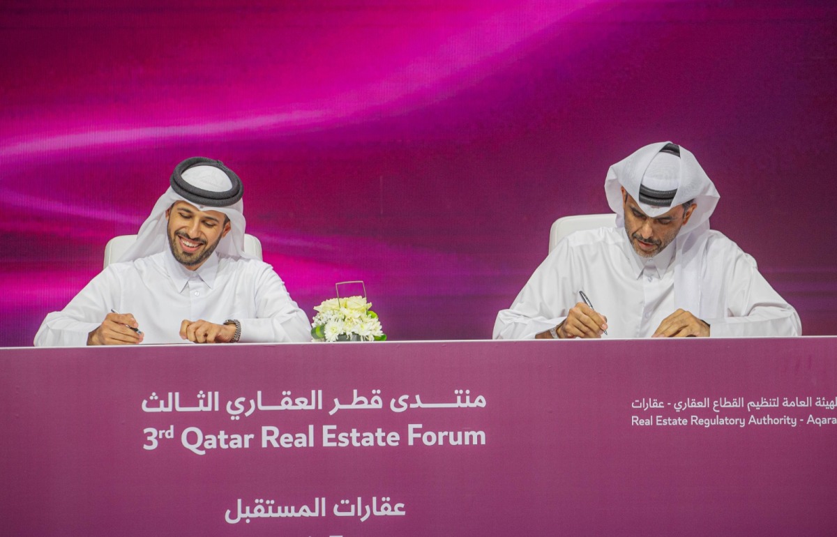 Aqarat Chairman Eng. Khalid bin Ahmed Al Obaidli with one of the officials during the signing of an MoU on the second day of Third Qatar Real Estate Forum, yesterday.
