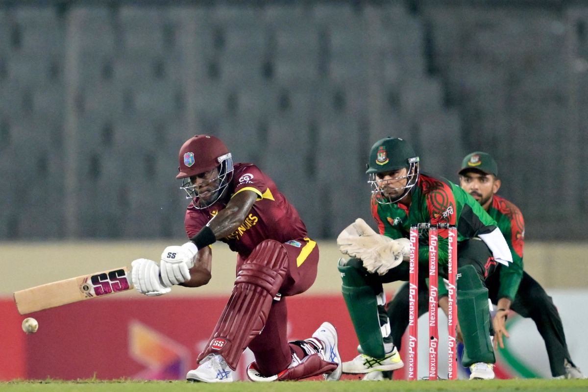 West Indies' Justin Greaves (L) plays a shot during the second one-day international (ODI) cricket match between Bangladesh and West Indies at the Sher-e-Bangla National Cricket Stadium in Dhaka on October 21, 2025. (Photo by Munir UZ ZAMAN / AFP)