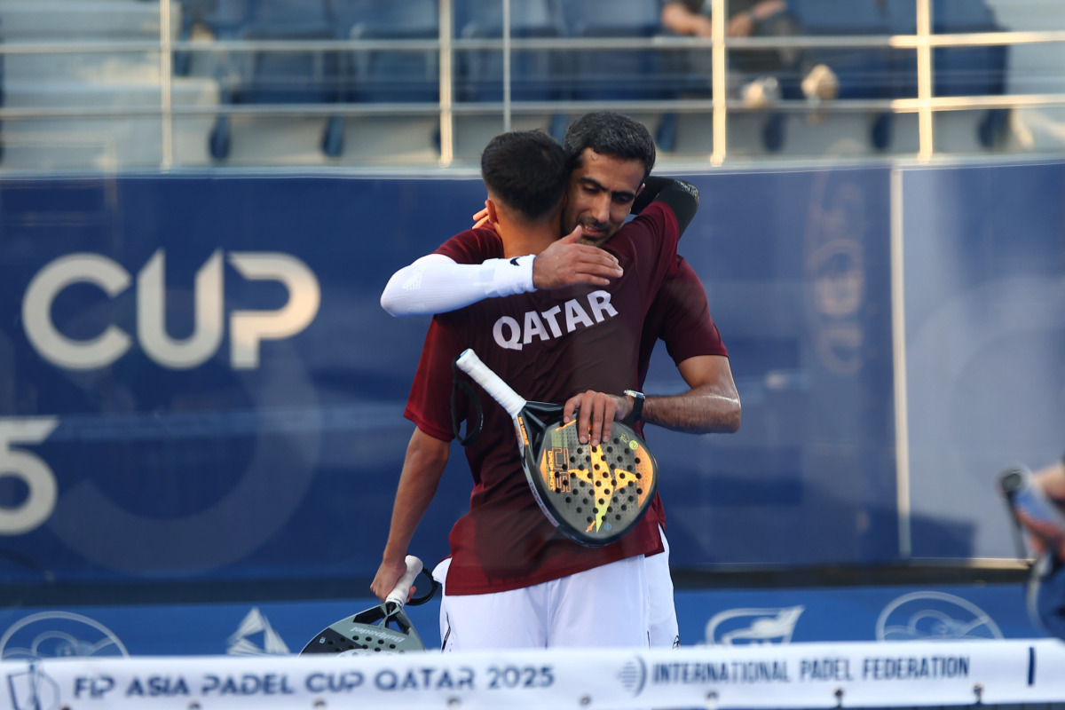 Qatar's Mohammed Saadon Al Kuwari (right) celebrates with a teammate