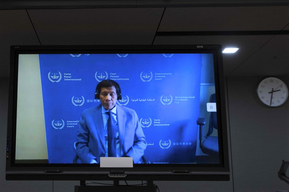 Former Philippine President Rodrigo Duterte is seen on a screen in the courtroom during his first appearance before the International Criminal Court (ICC) in The Hague on March 14, 2025. (Photo by Peter Dejong / POOL / AFP)

