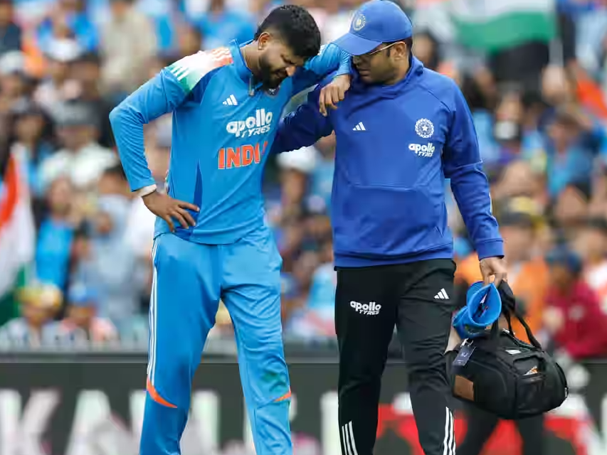 A medical team member helping Iyer off the pitch. Photo/BCCI