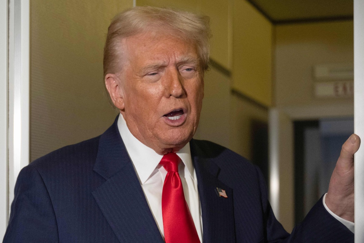 US President Donald Trump speaks to the media aboard Air Force One as he returns to the United States on October 30, 2025. (Photo by ANDREW CABALLERO-REYNOLDS / AFP)