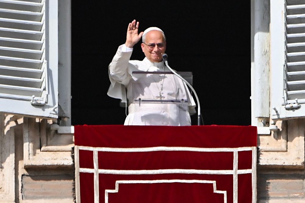 Pope Leo XIV waves to the crowd from the window of the apostolic palace overlooking St. Peter's square in The Vatican on November 2, 2025. (Photo by Andreas Solaro / AFP)
