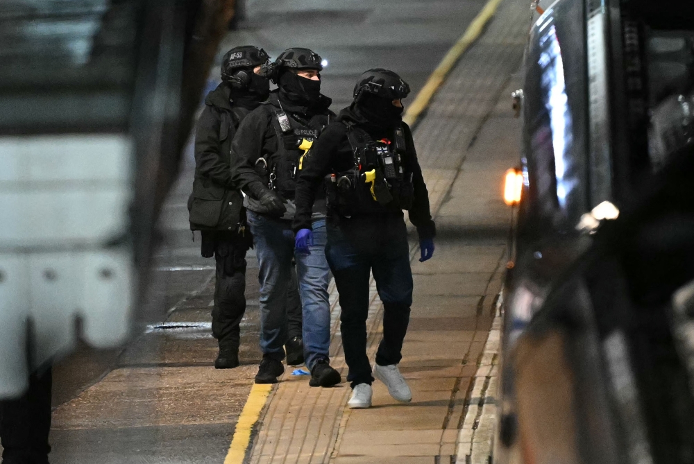Police officers walk along the platform near an LNER Azuma train at Huntingdon Station in Huntingdon, on November 1, 2025, following a stabbing on a train. Photo by Justin Tallis / AFP