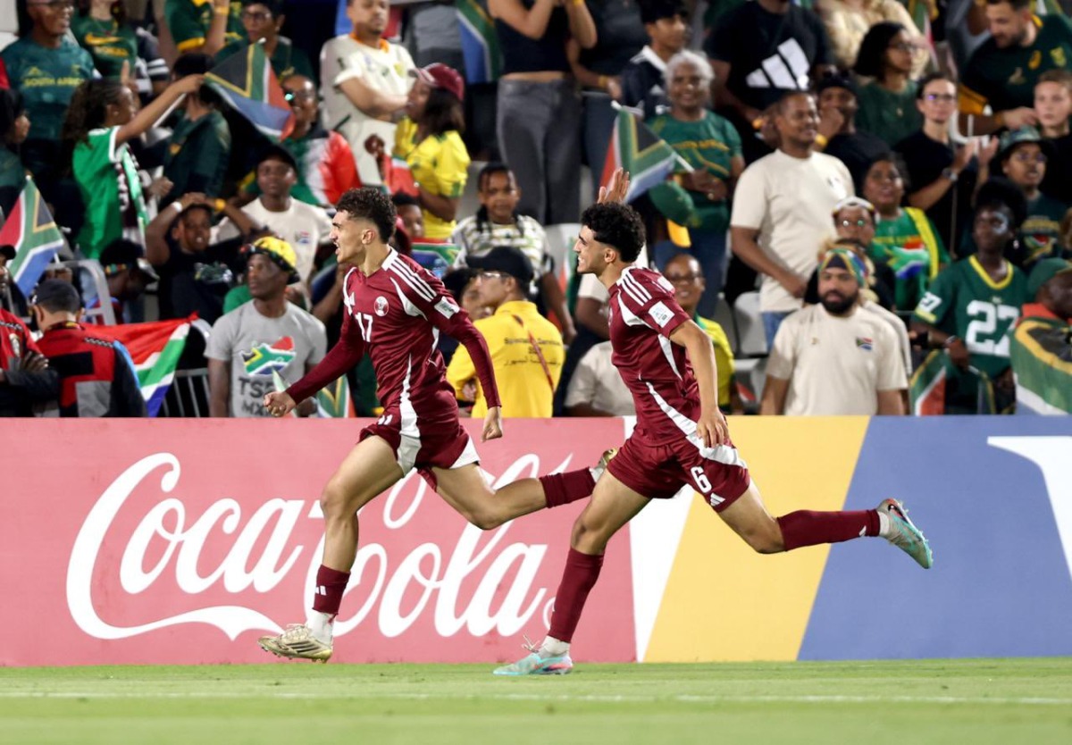 Qatar's Yazan Mohamed (left) celebrates with teammate Adam Friakh after scoring a goal against South Africa. 