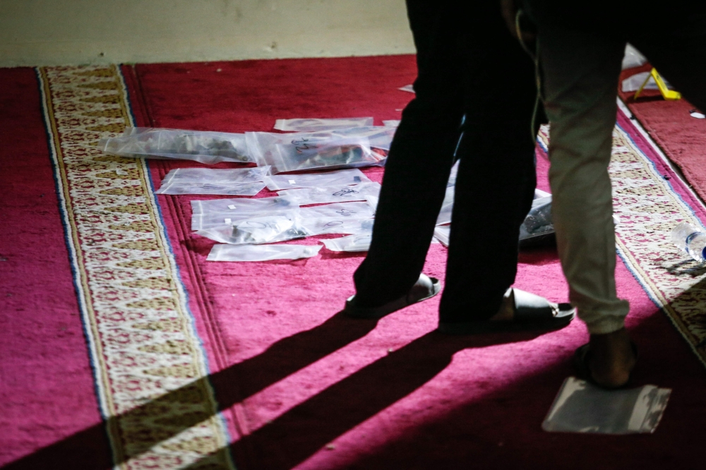Police officials carry out an on-site investigation following a blast at a mosque inside a school in Jakarta on November 7, 2025. Photo by Candra / AFP