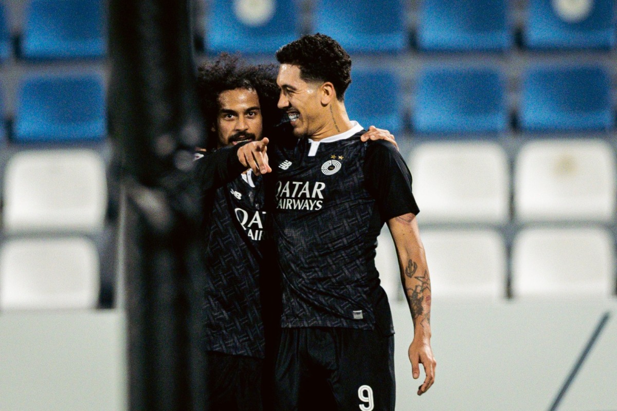 Al Sadd's Akram Afif (left) and Roberto Firmino celebrate.