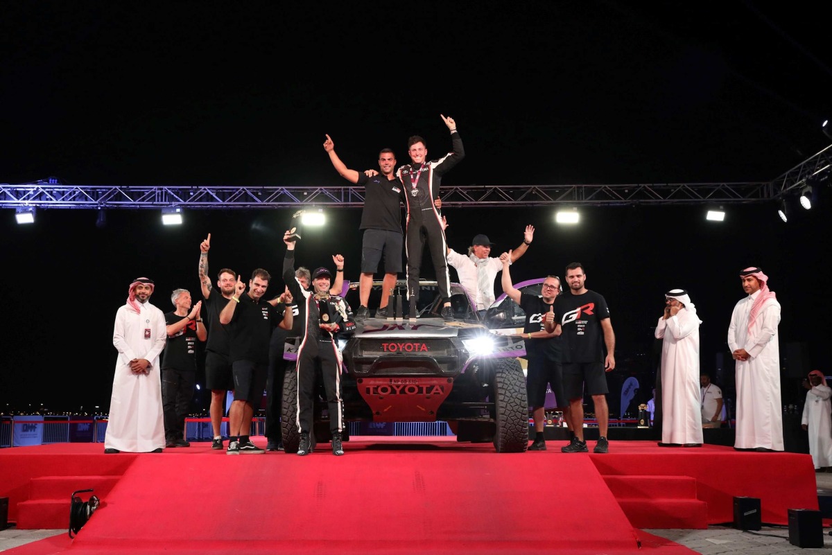 Toyota’s Juan Cruz Yacopini and Dani Oliveras celebrate their triumph with teammates. QMMF President Abdulrahman Al-Mannai, QMMF General Secretary Abdulrazzaq Al-Kuwari and QMMF Executive Director Amro Al Hamad are also present. 

