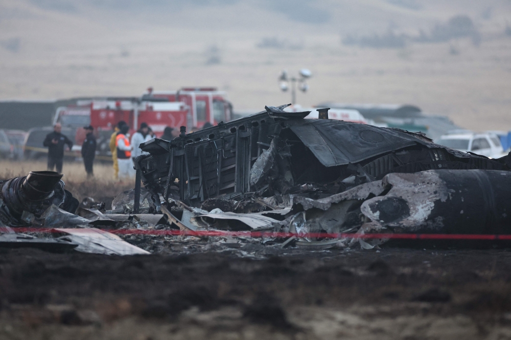 Wreckage is seen at the crash site of the Turkish C-130 military cargo plane in the Sighnaghi area at the Georgia-Azerbaijan border on November 12, 2025. (Photo by Giorgi Arjevanidze / AFP)
 
