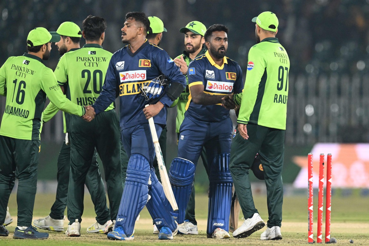 Sri Lanka's Maheesh Theekshana (CL) and Sri Lanka's Asitha Fernando (CR) shake hands with Pakistan's players at the end of the first one-day international (ODI) cricket match between Pakistan and Sri Lanka at the Rawalpindi Cricket Stadium in Rawalpindi on November 11, 2025. (Photo by Aamir QURESHI / AFP)