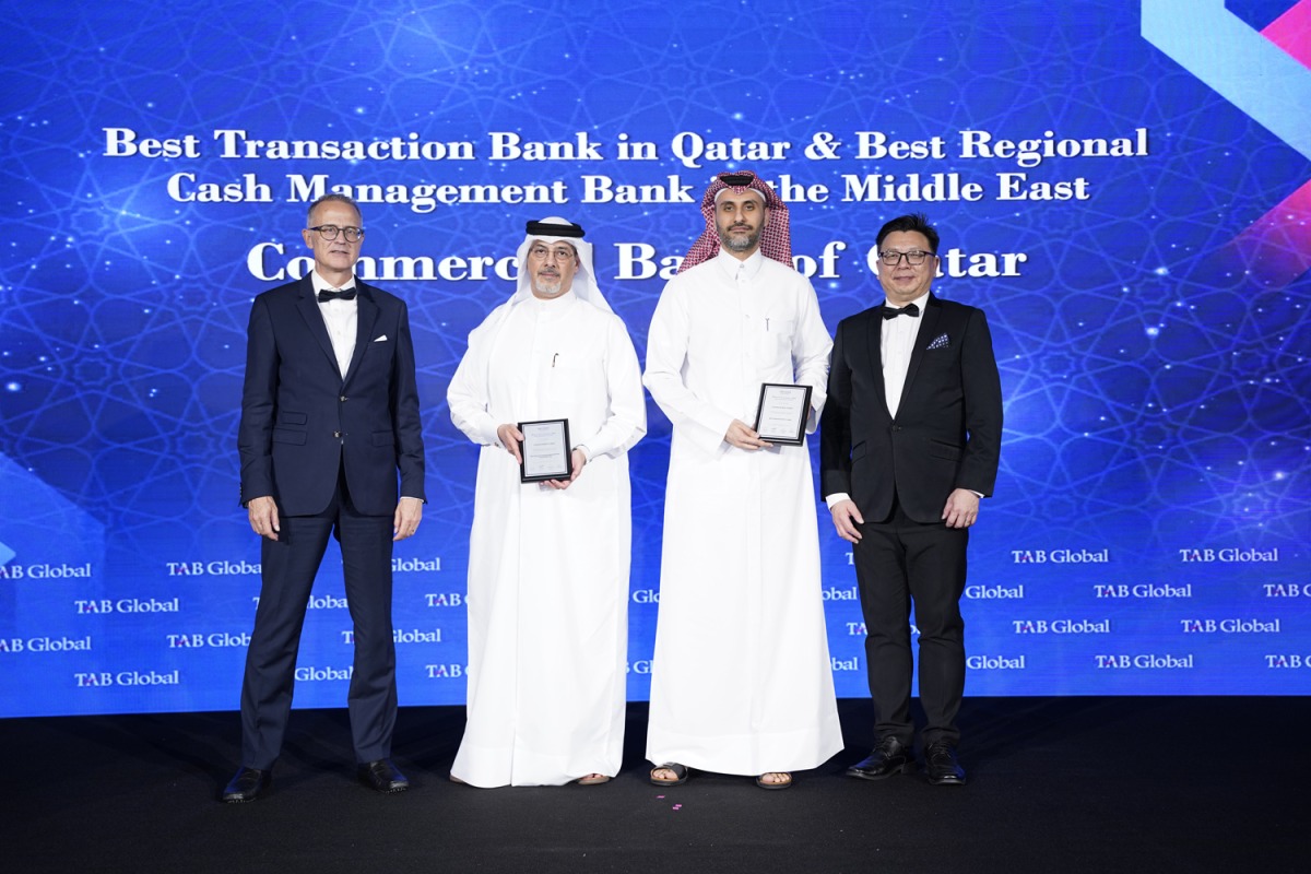 Commercial Bank officials with the awards.