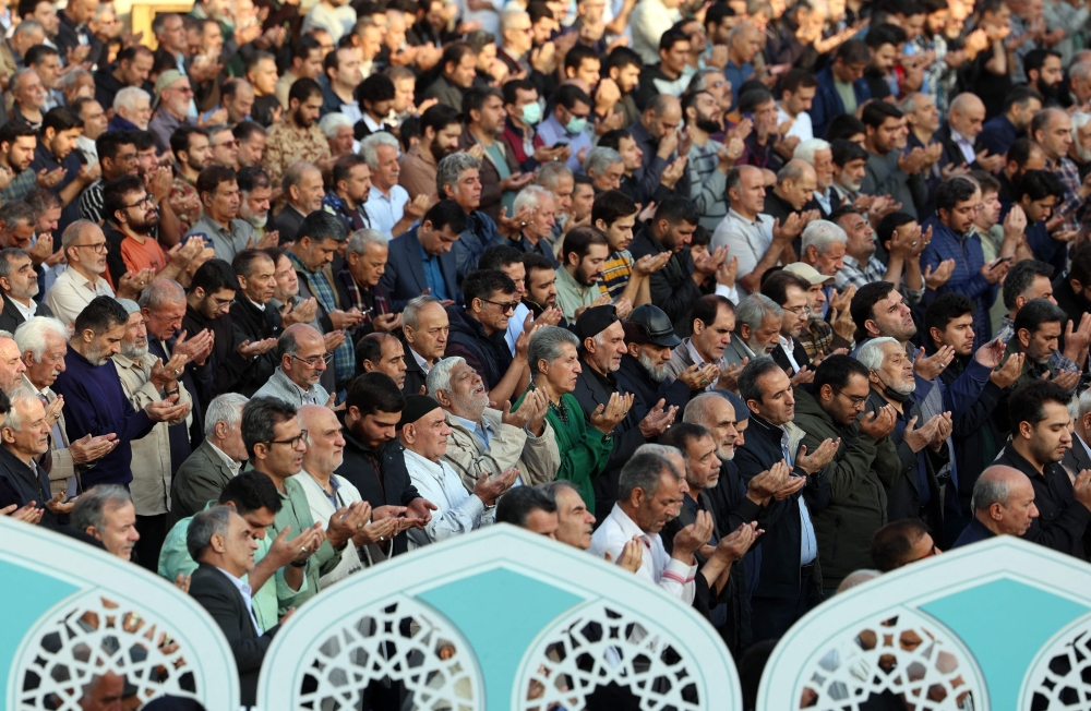 Iranians perform a prayer for rainfall at the Saleh Shrine in Tehran on November 14, 2025, as the country suffers from severe water shortages. Authorities in Tehran warned last week of possible rolling cuts to water supplies in the capital amid what officials call the worst drought in decades. (Photo by AFP) 