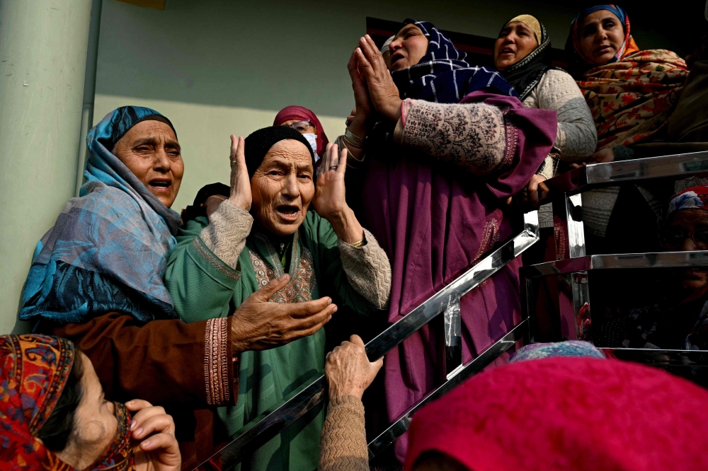 Relatives of the victims who died in an accidental blast at Nowgam police station, mourn in their house on the outskirts of Srinagar, on November 15, 2025. (Photo by Tauseef Mustafa / AFP)