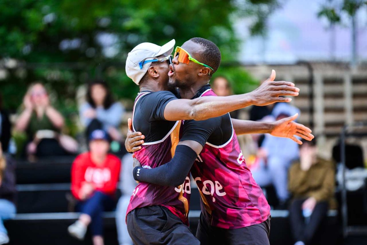 Qatar’s Cherif Younousse (right) and Ahmed Tijan celebrate.