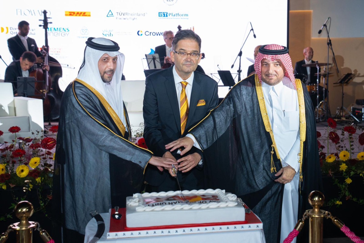 Minister of Public Health, H E Mansoor bin Ebrahim bin Saad Al Mahmoud; Director of the Protocol Department at MoFA, H E Ibrahim Yousif Abdullah Fakhro; and Ambassador of Germany to Qatar H E Oliver Owcza cutting the cake to celebrate  the Day of German Unity. 