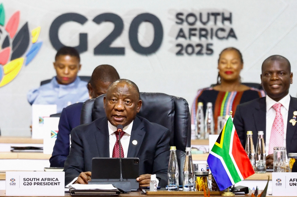 South Africa's President Cyril Ramaphosa gives the opening speech as he chairs the G20 Leaders' Summit plenary session at the Nasrec Expo Centre in Johannesburg on November 22, 2025. (Photo by Thomas Mukoya / POOL / AFP)