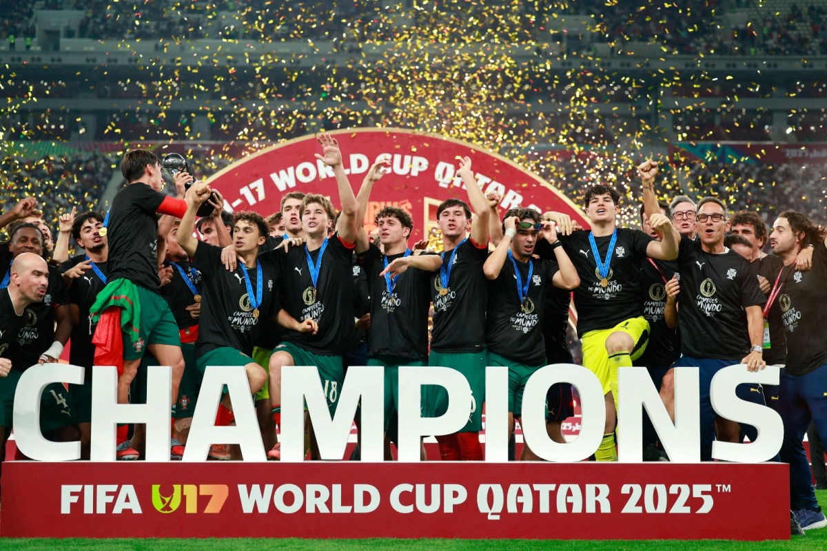 AFP photo of Portugal's players celebrate with the trophy on the podium after the FIFA U17 World Cup final football match between Portugal and Austria at Khalifa International Stadium in Al-Rayyan on November 27, 2025.