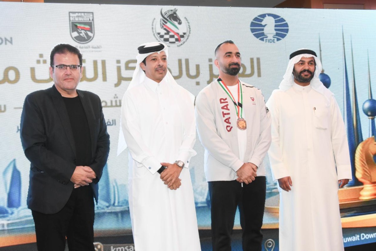 Qatar Chess Federation President Mohammed Al Mudahka poses for picture with International Master Hussein Aziz, who won open blitz bronze. 
