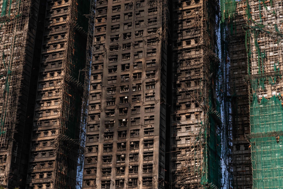 A general view shows the aftermath of a major fire that swept through several apartment blocks at the Wang Fuk Court residential estate in Hong Kong's Tai Po district on November 28, 2025. (Photo by Dale DE LA REY / AFP)
