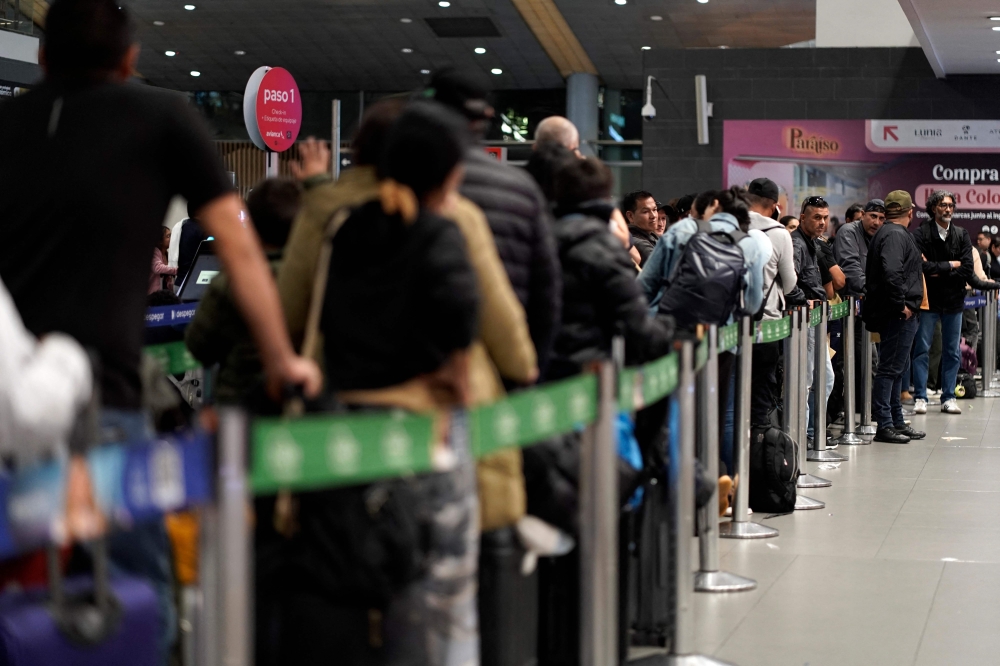 Passengers are pictured at El Dorado airport in Bogota on November 28, 2025. Colombian airline Avianca reported on Friday 
