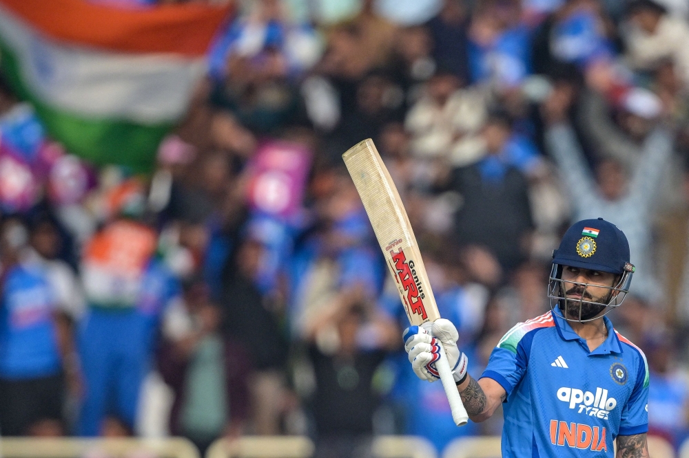 India's Virat Kohli celebrates after scoring a half-century (50 runs) during the first one-day international (ODI) cricket match at the JSCA International Stadium in Ranchi on November 30, 2025. (Photo by Dibyangshu Sarkar / AFP) 