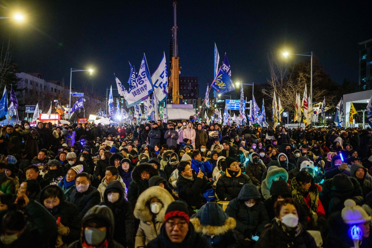 Protesters take part in a rally near the National Assembly in Seoul on December 3, 2025, to mark the first anniversary of the declaration of martial law by ousted president Yoon Suk Yeol. Photo by ANTHONY WALLACE / AFP