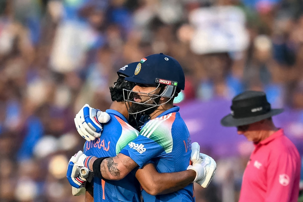 India's Virat Kohli (R) congratulates Ruturaj Gaikwad as he celebrates after scoring a century (100 runs) in Raipur on December 3, 2025. (Photo by Noah Seelam / AFP) 