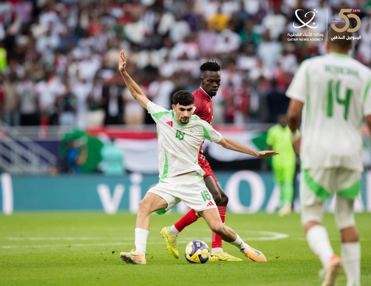 Algeria's Redouane Berkane (foreground) controls the ball.