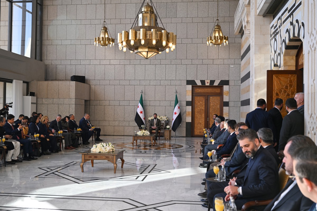 Syrian President Ahmed al-Sharaa (C) attends a reception with United Nations Security Council delegation at the Presidential Palace in Damascus on December 4, 2025. Photo by Louai Beshara / AFP