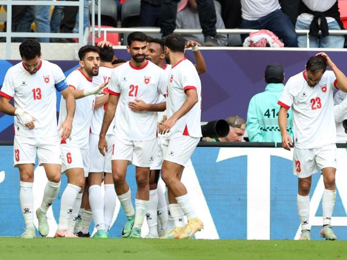 Jordan players celebrate after scoring a goal.