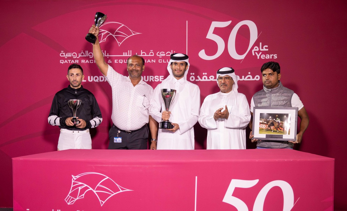 The connections of August George celebrate with their trophies. PICS: Juhaim/QREC