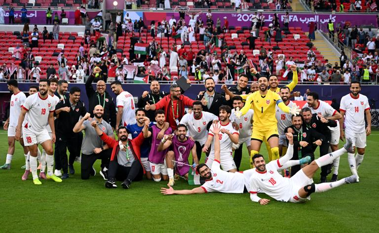 Jordan players celebrate their victory.