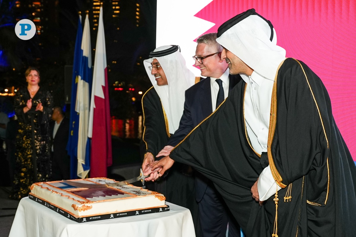 Minister of Labour H E Dr. Ali bin Smaikh Al Marri; Minister of Transport H E Sheikh Mohammed bin Abdullah bin Mohammed Al-Thani; and Ambassador of Finland to Qatar H E Juha Mustonen cut a cake to mark the occasion at an event in Doha yesterday. Pic: Mohamed Al Attar/ The Peninsula