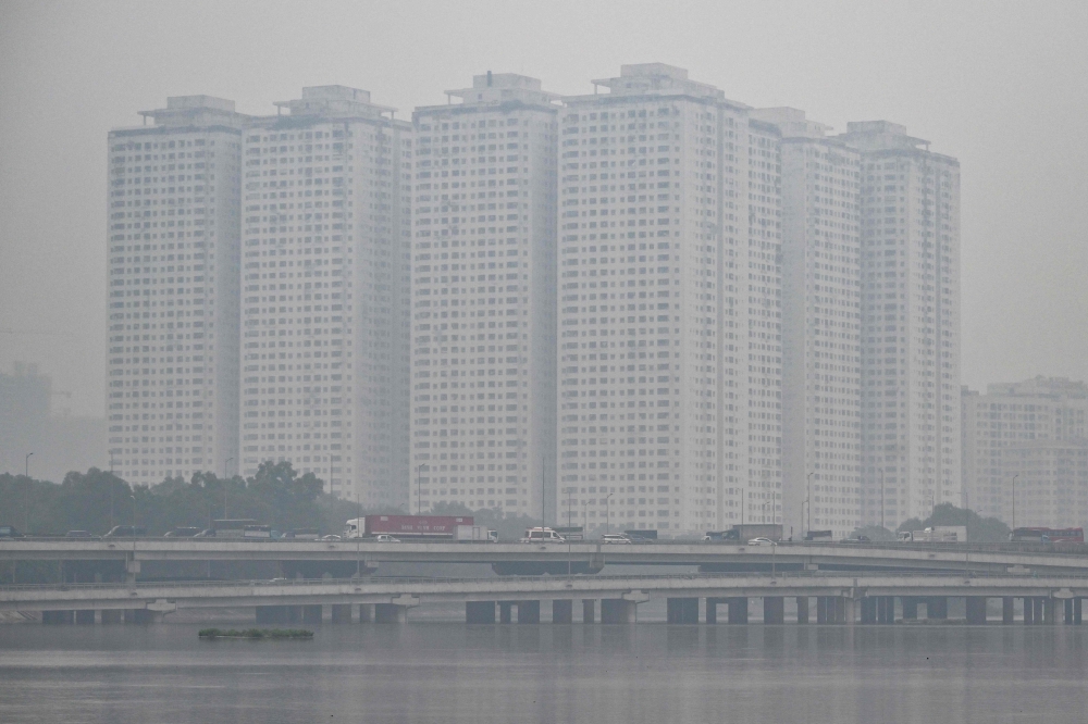 This picture shows vehicles driving on a highway amid heavy air pollution conditions in Hanoi on December 11, 2025. (Photo by Nhac Nguyen/ AFP)
