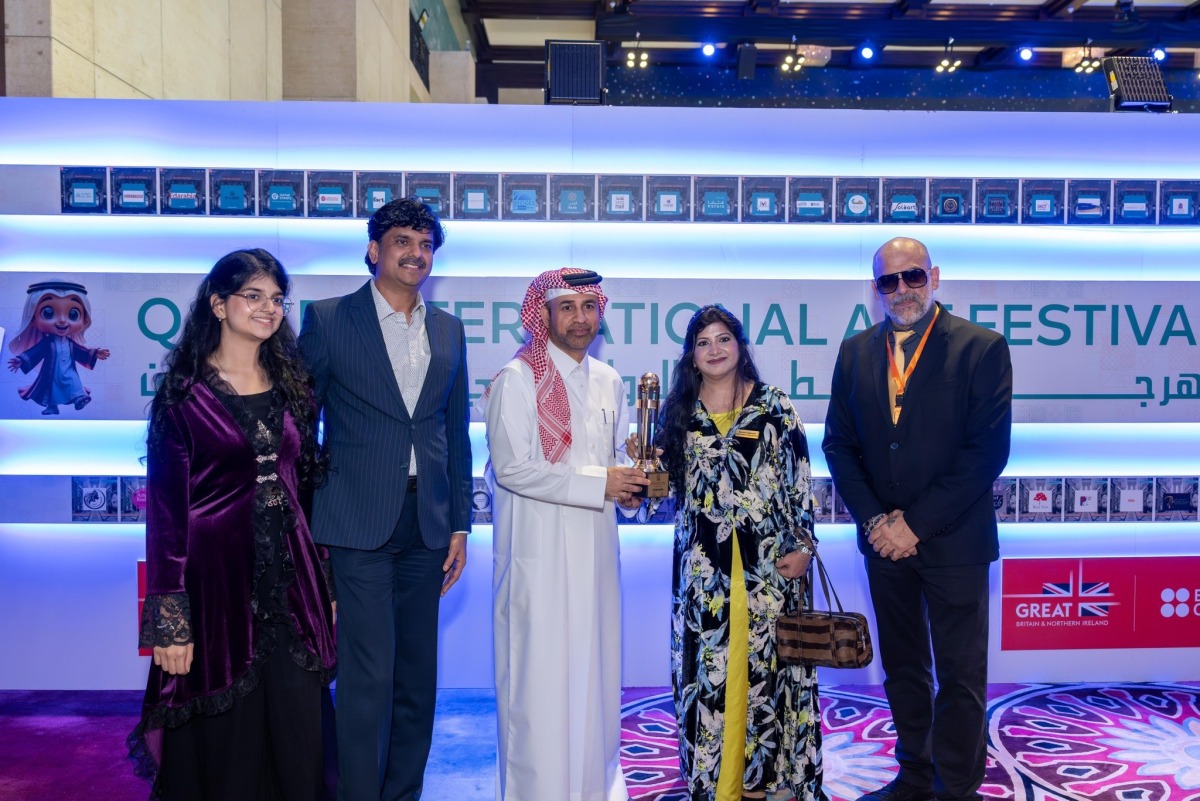 General Manager of Katara H E Prof. Dr. Khalid bin Ibrahim Al-Sulaiti honouring one of the winning artists.