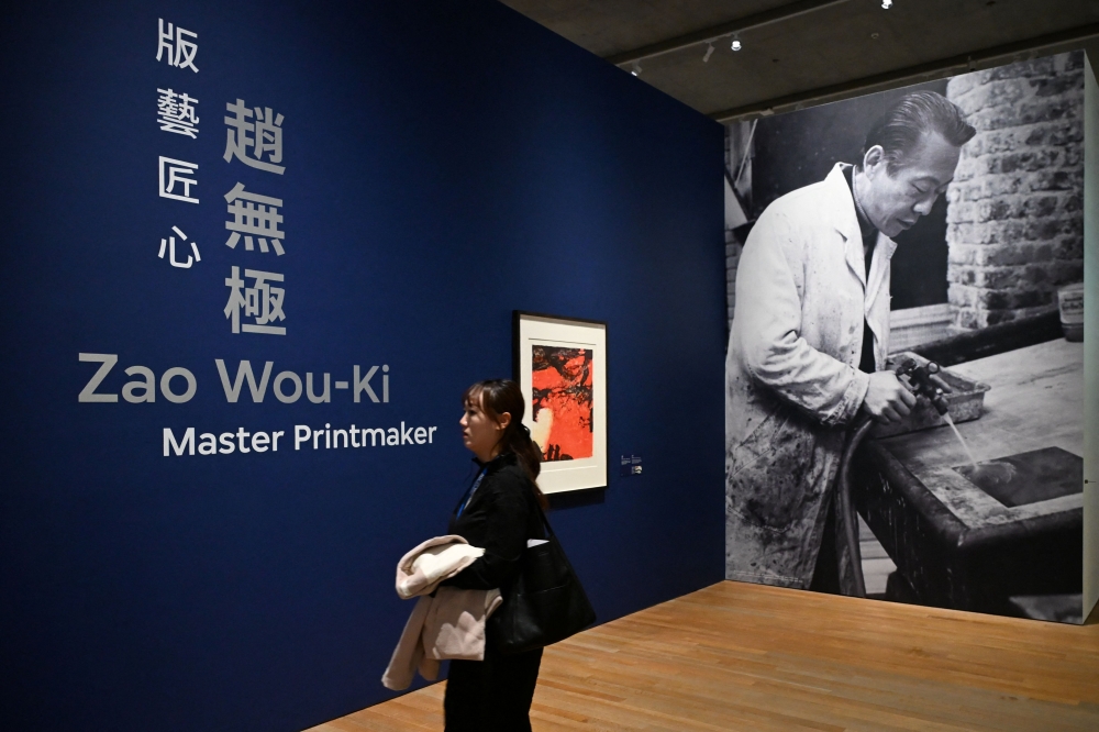 A woman attends a media preview of M+ art museums special exhibition titled 