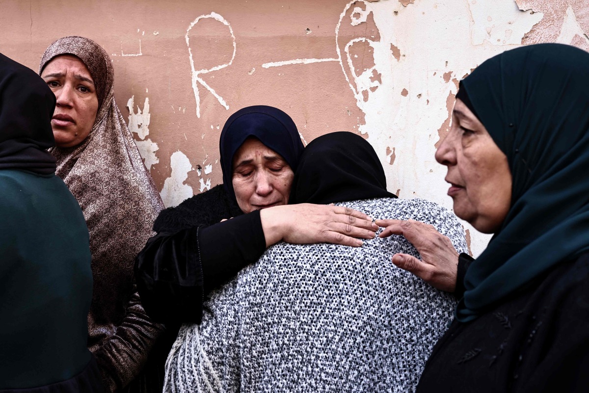 Women grieve during the funeral of Ahmad Zyoud in the village of Silat al-Harithiya, close to the northern West Bank city of Jenin on December 21, 2025. Photo by Zain JAAFAR / AFP