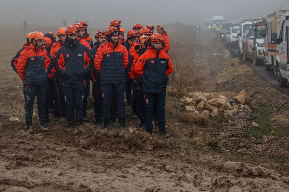 Rescuers work as search and rescue operations continue at the wreckage site following the crash of a Libya-bound business jet carrying Libyan Chief of Staff General Muhammad Ali Ahmed Al-Haddad, found 2 kilometers south of Kesikkavak Village at Haymana district in Ankara on December 24, 2025. (Photo by Adem Altan / AFP)
