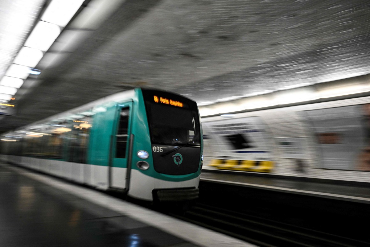 This photograph shows a subway train entering a metro station in Paris on April 1, 2024. Photo by JULIEN DE ROSA / AFP