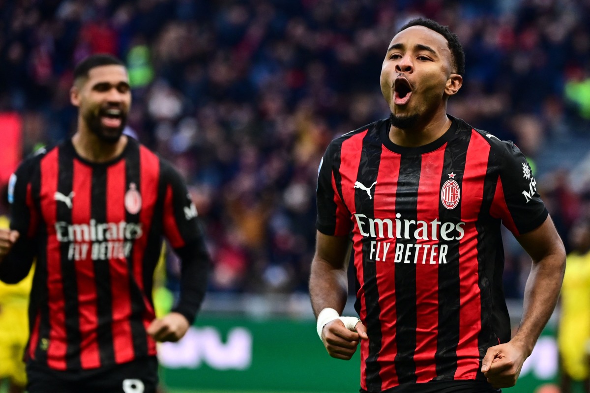 AC Milan's French forward #18 Christopher Nkunku celebrates after scoring his team second goal against Hellas Verona at the San Siro stadium in Milan. (Photo by Piero CRUCIATTI / AFP)